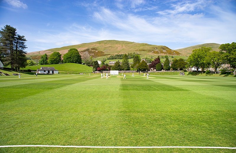 The vast green cricket field and rolling hills at Sedbergh School